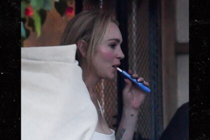 lindsay lohan vapes eats ice cream in miami with husband son 692f52b378e54